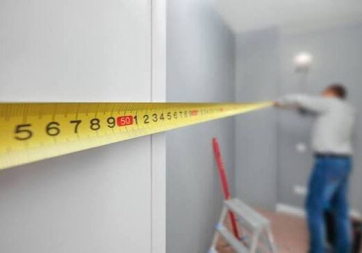 man measuring room